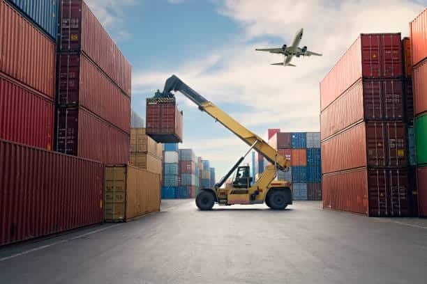 Airplane flying above container port. Airplane flying above container port. Air freight stock pictures, royalty-free photos & images