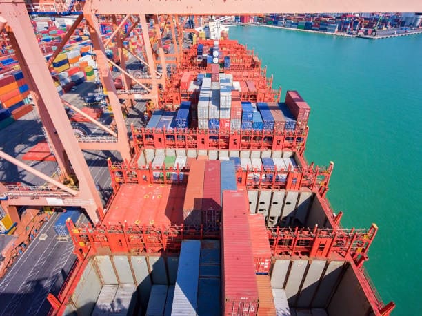 Containers being loaded onto vessel at Hamburg Port for export to the US.