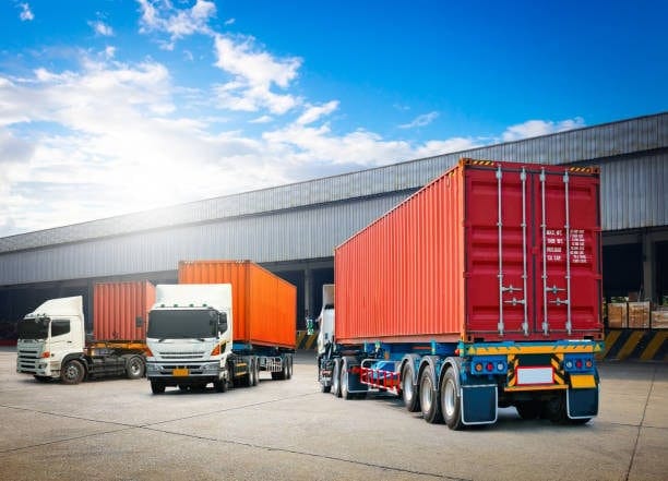 Container trucks parked at a customs warehouse facility, ready for clearance procedures and document verification before distribution.