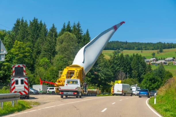 Specialized truck transporting oversized cargo, such as a wind turbine blade, in Germany.