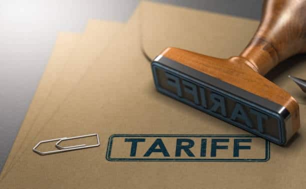 Rubber stamp labeled “TARIFF” pressed onto official documents, symbolizing duties and import taxes applicable to goods sourced from China.