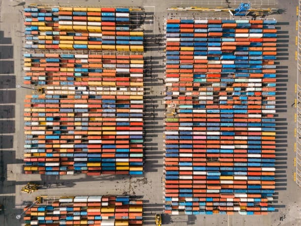 Aerial view of organized, colorful shipping containers at a freight terminal.