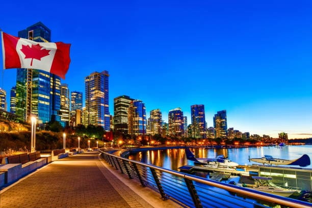 View of Vancouver skyline with Canadian flag, representing a major shipping destination in Canada.