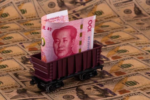 Chinese yuan in a railcar on US dollar notes symbolizing CPT international freight cost responsibilities.