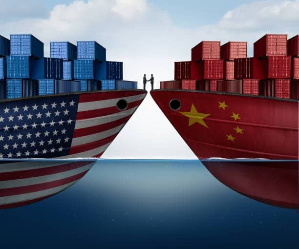 Freight ships with US and China flags shaking hands, representing shipping agreements and container cost negotiation.