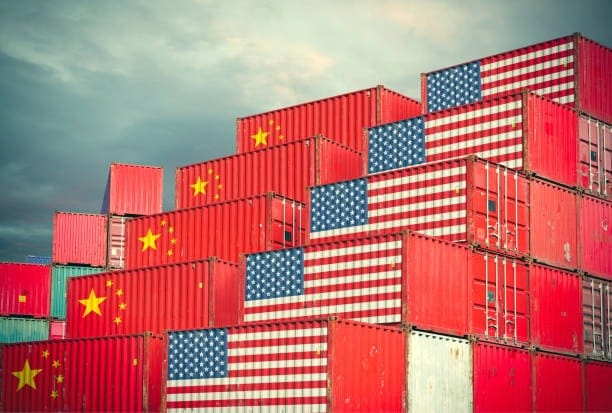 Shipping containers marked with China and USA flags representing international trade and freight routes.