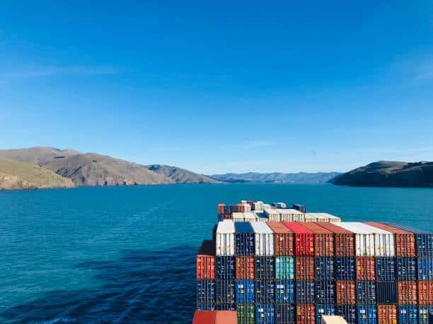 Cargo vessel carrying shipping containers en route to New Zealand via sea freight.