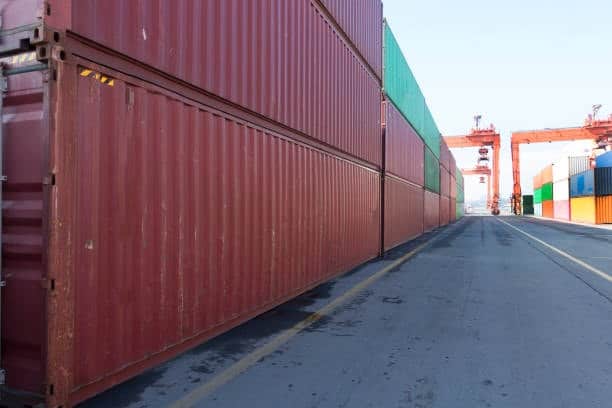 Rows of containers at a shipping terminal, illustrating the port staging area before inland delivery.