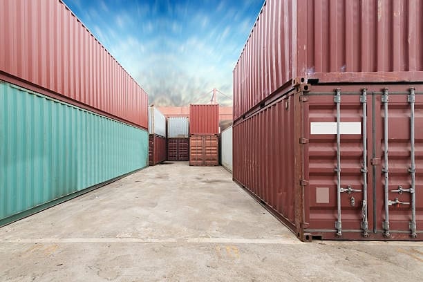 Pathway through a container yard, representing the transition from port storage to inland door delivery.