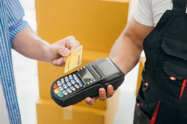 Close-up of contactless card payment representing cost responsibility under CPT.