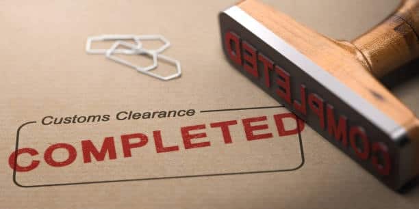 Customs clearance completed stamp on shipping documentation.