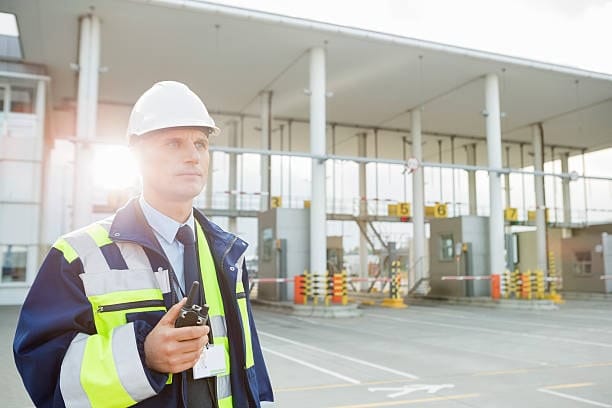 Customs security officer monitoring operations at a border clearance area.