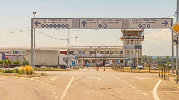 Directional signs at a customs and cargo terminal checkpoint.