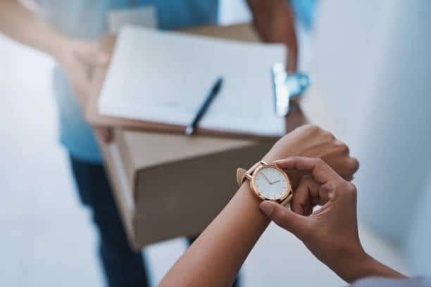 Customer checking time while receiving a package shipped from Canada to the US.