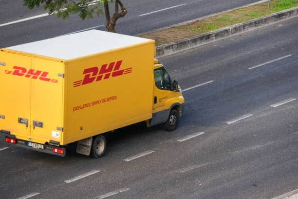 DHL delivery truck on a highway, representing efficient road logistics for shipments from China to the USA.