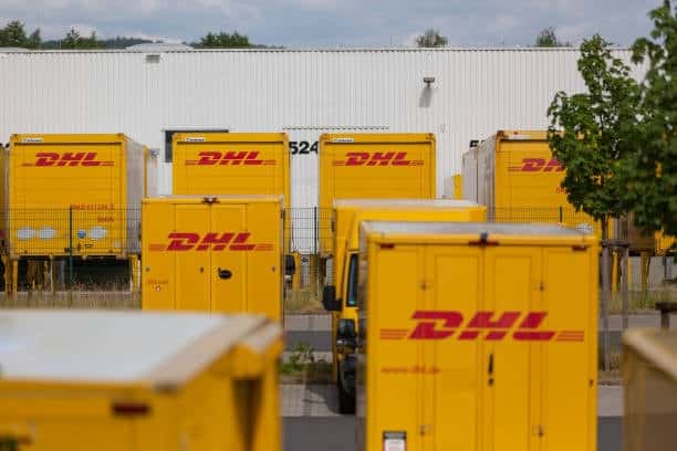 DHL trucks at a logistics hub preparing for international delivery including China to USA express shipments.