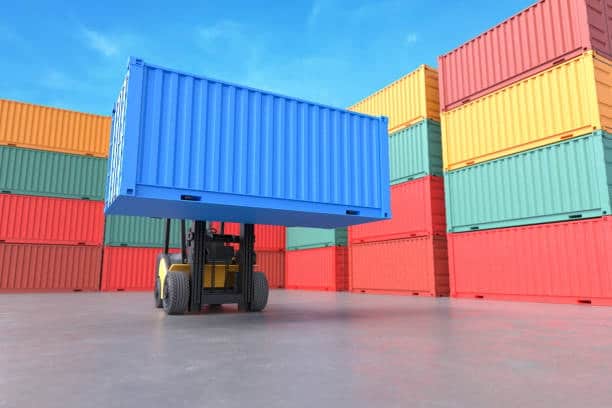Forklift lifting a blue container in a terminal, demonstrating container handling in port-to-door services.