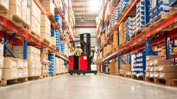 Forklift transporting large boxes inside a warehouse for big box shipping operations.