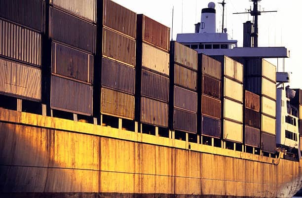 Shipping containers on a freight vessel for outbound international logistics.