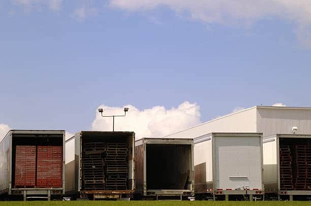 Warehouse loading docks with trailers for freight out transportation.