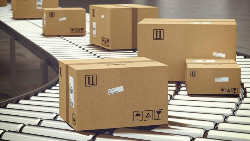 Cardboard parcel boxes on conveyor belt representing small freight out processing.