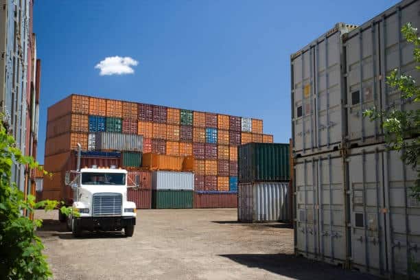 Shipping containers in storage yard awaiting freight out dispatch.