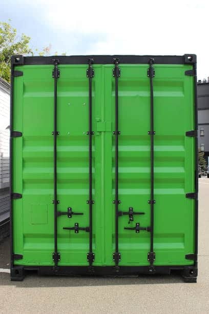 Front view of a green 20-foot shipping container, commonly used for freight shipments to India.