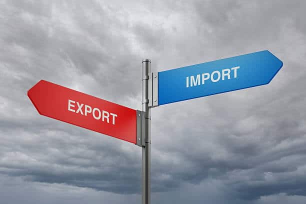 Signpost showing import and export directions for cross-border shipping between Canada and the US.