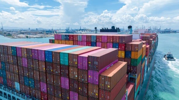 Massive cargo vessel loaded with containers departing from China for shipping to the United States.