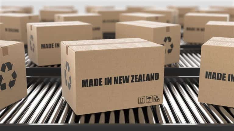 Cardboard boxes labeled "Made in New Zealand" on a conveyor belt, representing local exports.