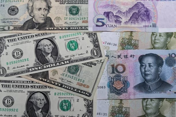 Assorted US and Chinese currency bills illustrating customs duties and import fees for goods from China to the USA.