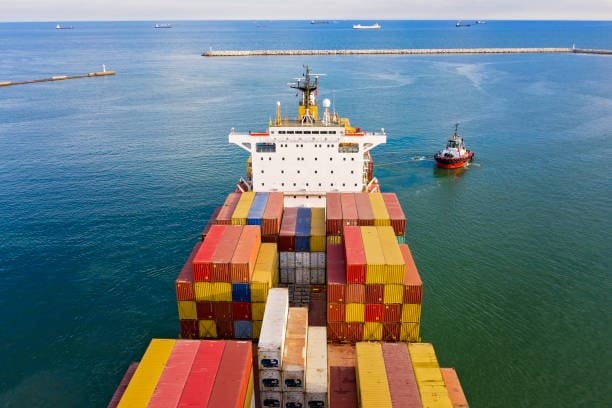 Back view of container vessel transporting goods for export from China to the USA.