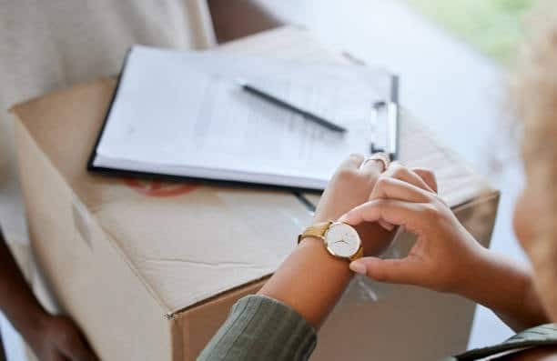 Customer checking delivery time while receiving a package shipped from Canada to the US.