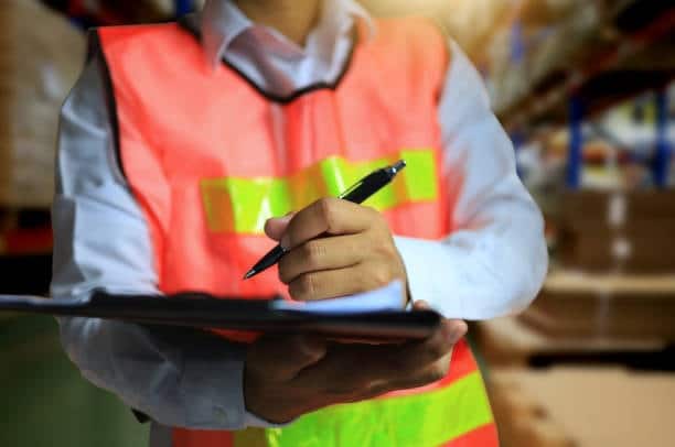 Logistics worker checking shipment documentation for deliveries from Canada to the US.