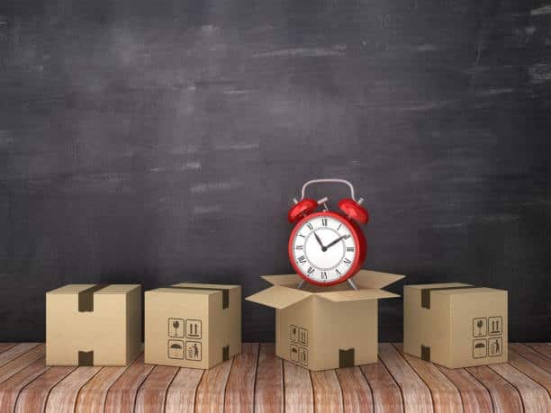 Boxes with an alarm clock symbolizing urgency and shipping time from Canada to the United States.