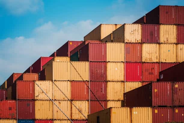 Stacked colorful shipping containers prepared for SF Express exports to the USA.