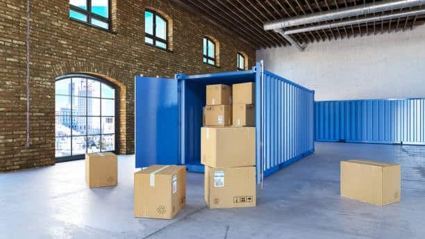 Open container with cardboard boxes inside a warehouse, symbolizing the final stage of port-to-door delivery.