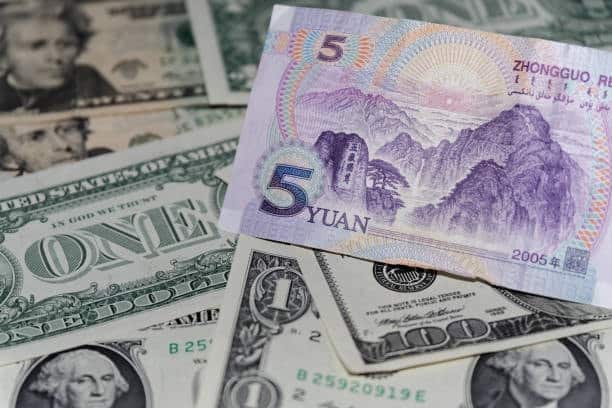 Close-up of Chinese Yuan and US Dollar bills representing currency exchange in international trade from China to the US.