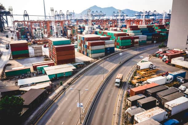 Busy container port with trucks and cargo ready for international shipping documentation