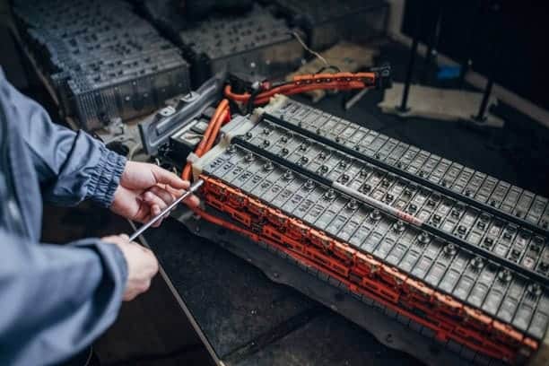 Technician repairing lithium-ion battery pack for safe transportation