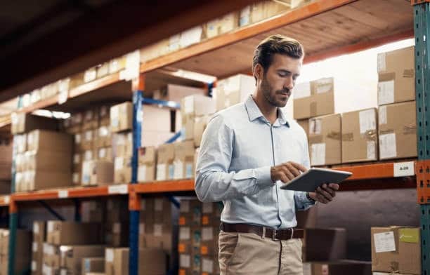 Man using digital tools to manage shipping for French imports.