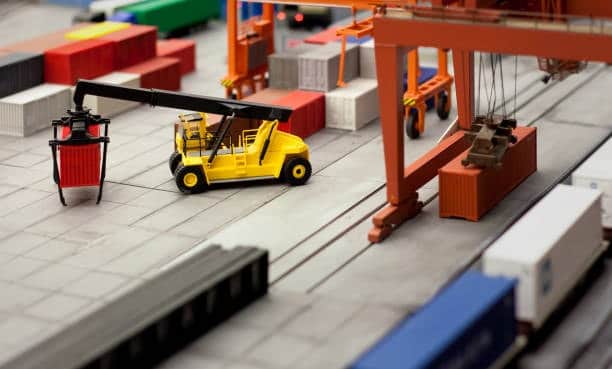 Toy crane handling containers, representing logistics in toy importing.