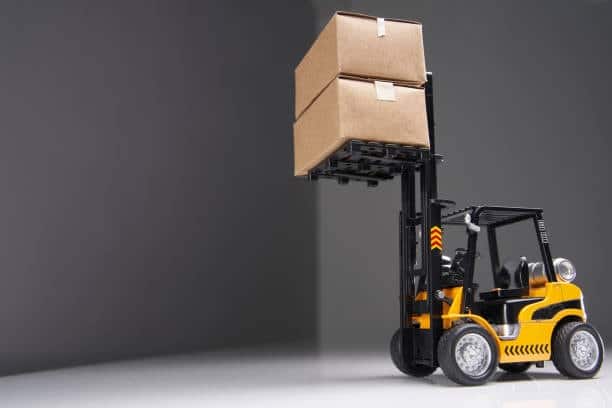 Toy forklift lifting boxes, symbolizing the handling of imported toy shipments.