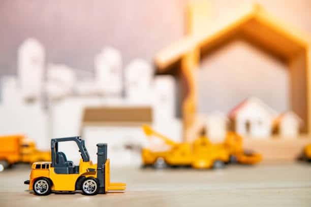 Miniature forklift toy symbolizing logistics and toy shipping operations.