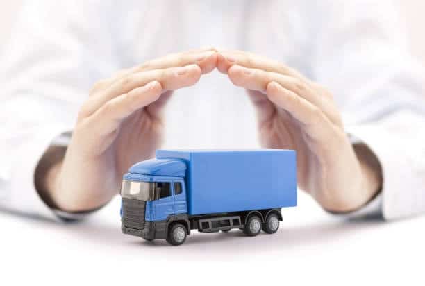 Miniature truck protected by hands, symbolizing safe toy shipping and compliance.